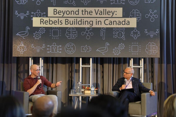 Tobias Lütke speaking with Vivek Goel on a stage