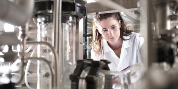 Waterloo chemical engineering student wearing goggles works in a lab