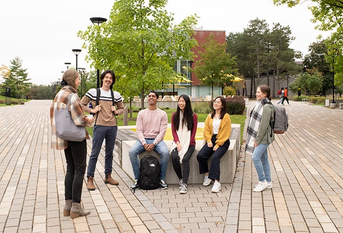 group of students sitting on a bench