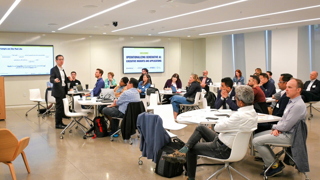 Jimmy Lin speaking to a group of business and technology leaders on the practical use of artificial intelligence