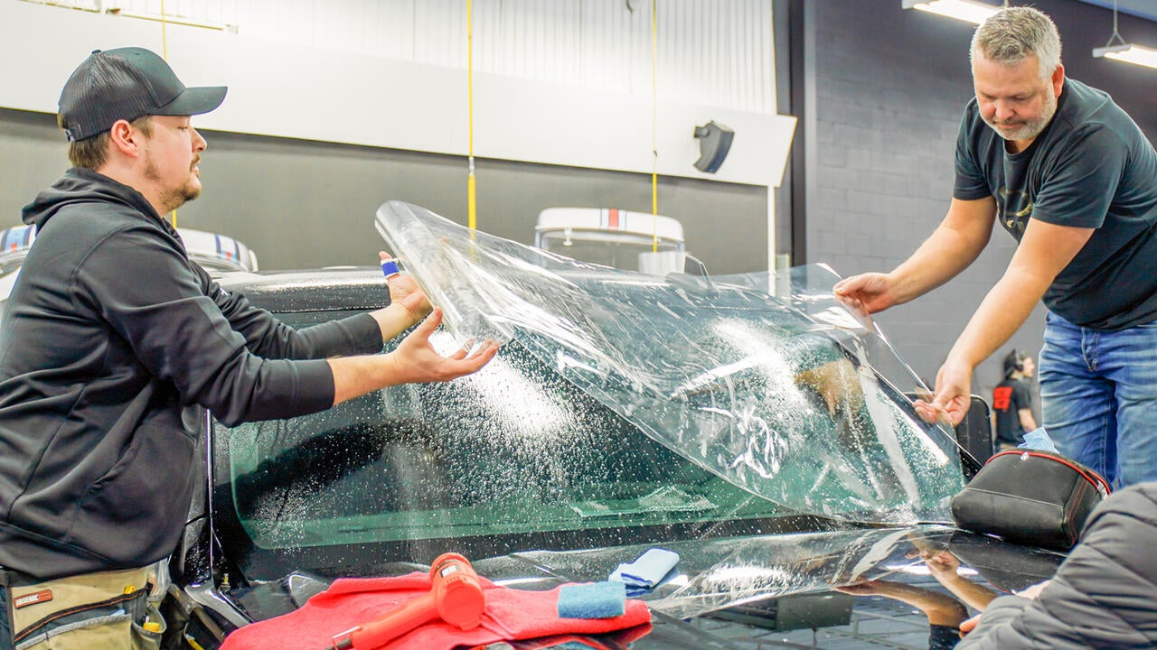 ExoShield being installed on a vehicle by two installers