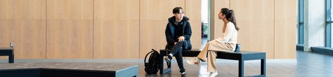 Two students sitting on a bench