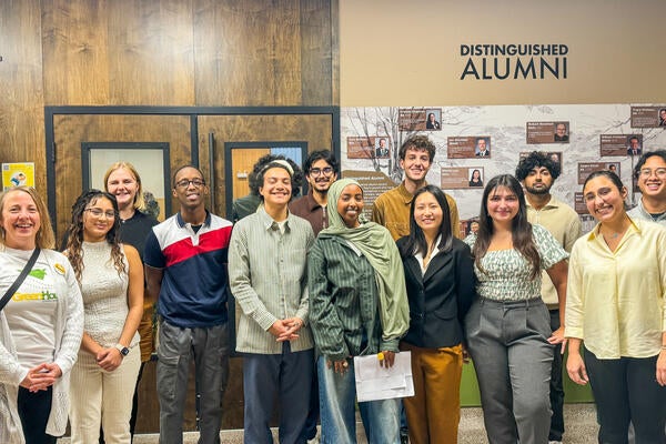 University of Waterloo students and United College staff pose for a group photo together in front of the College's Alumni Hall