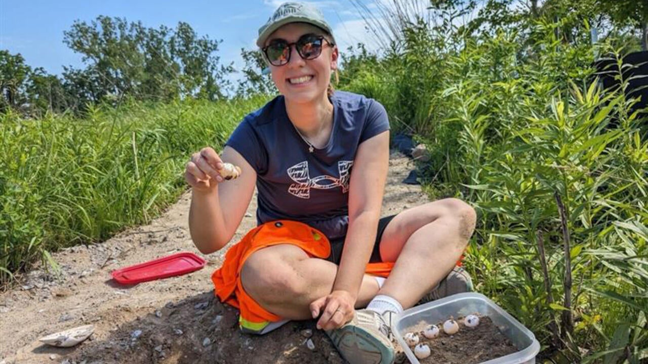 Katja Kubasta holding a turtle.
