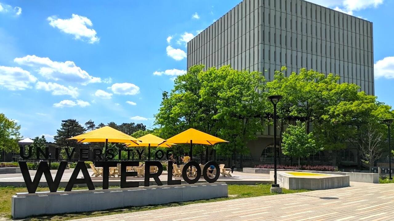 University of Waterloo sign outdoors on a summer day