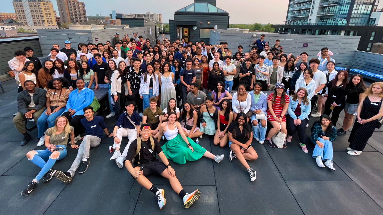 A group of students pose on a rooftop