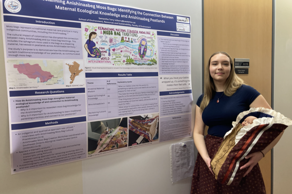 Samantha Terry with her moss bag and research poster.