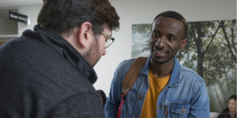 Student talking with another student on campus