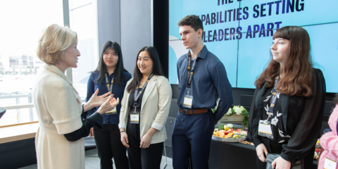 Adult talking to a group of students